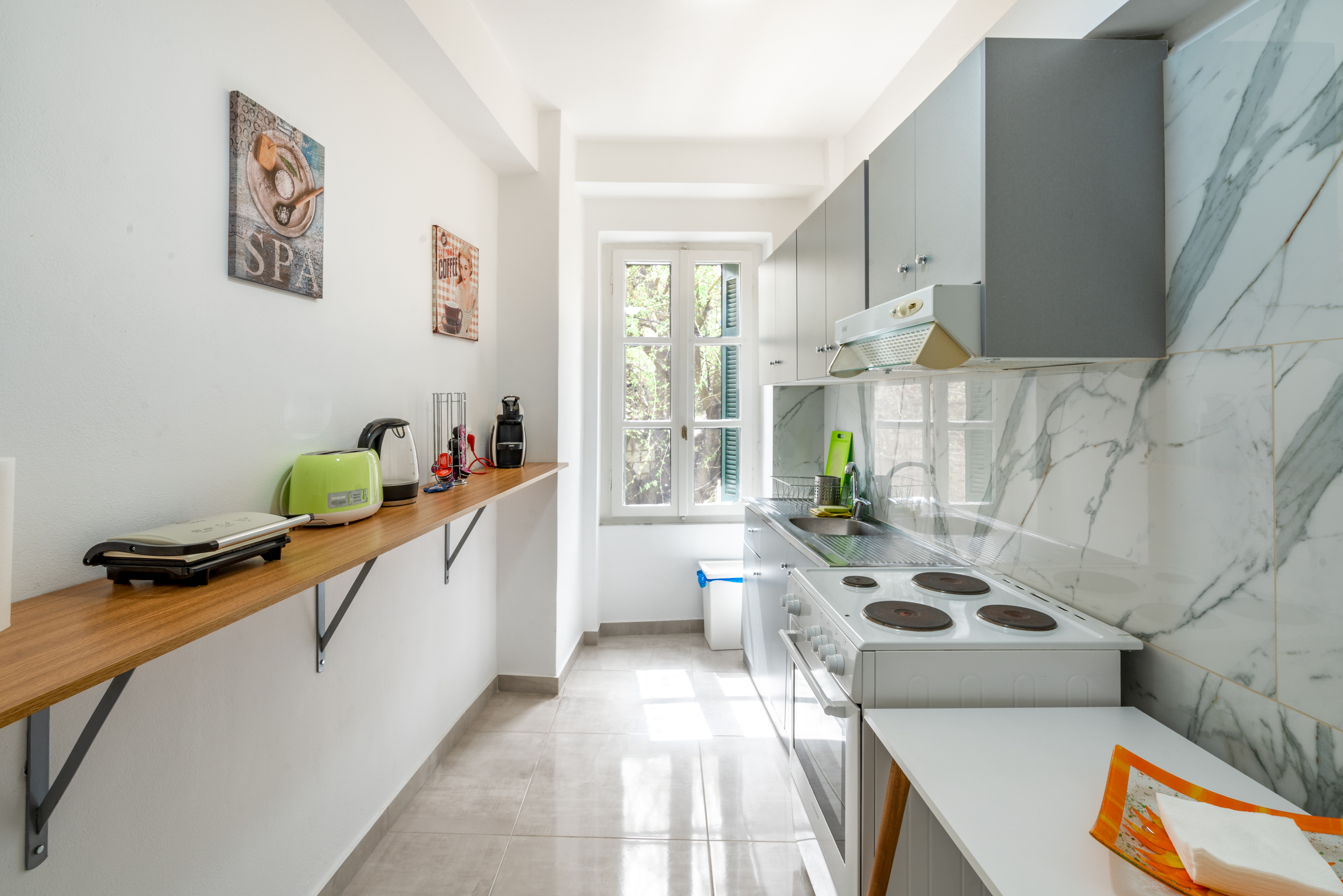 Fully equipped kitchen area with modern appliances and breakfast preparation space