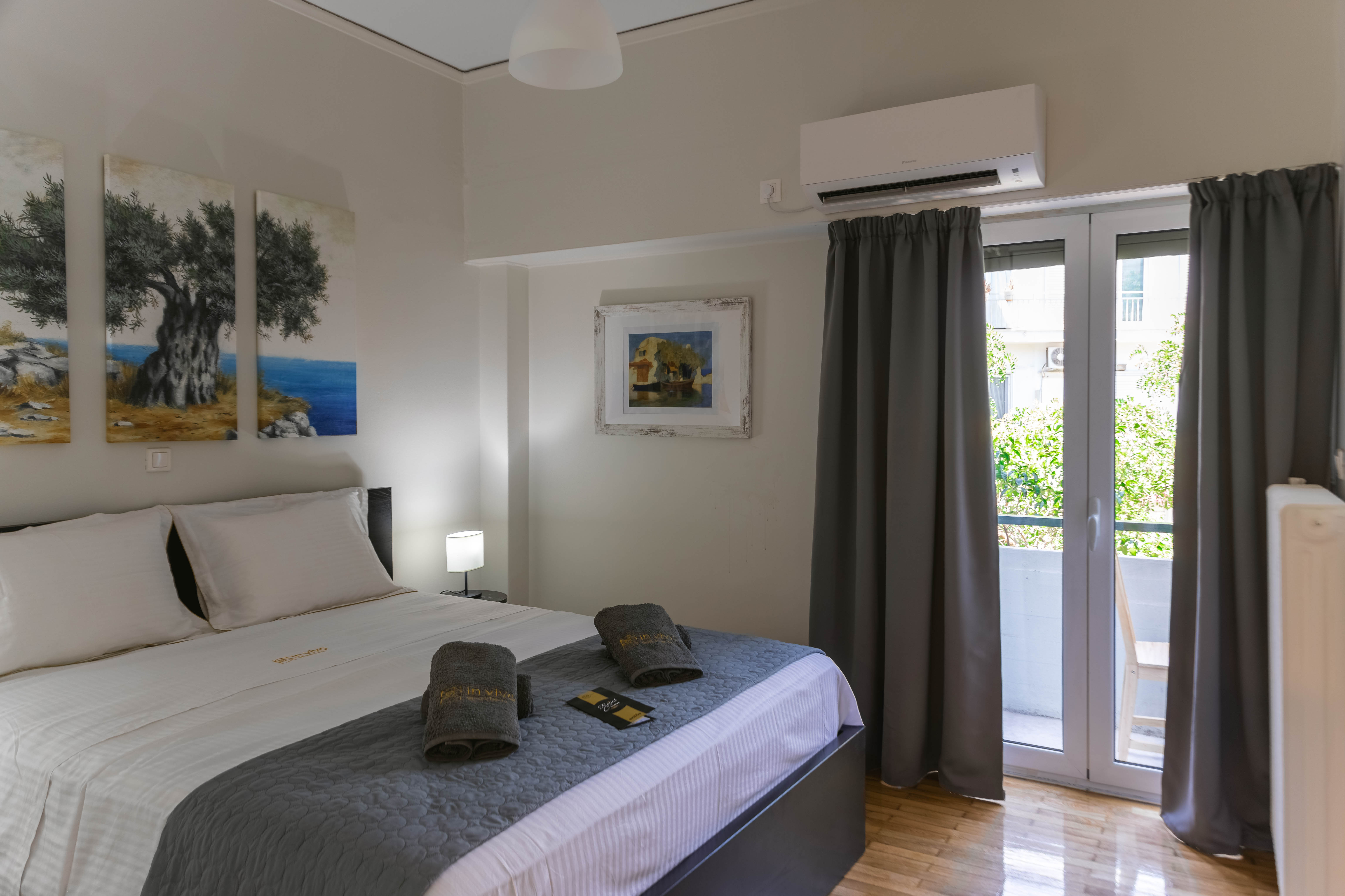 Master bedroom with balcony access in Mets Gem apartment