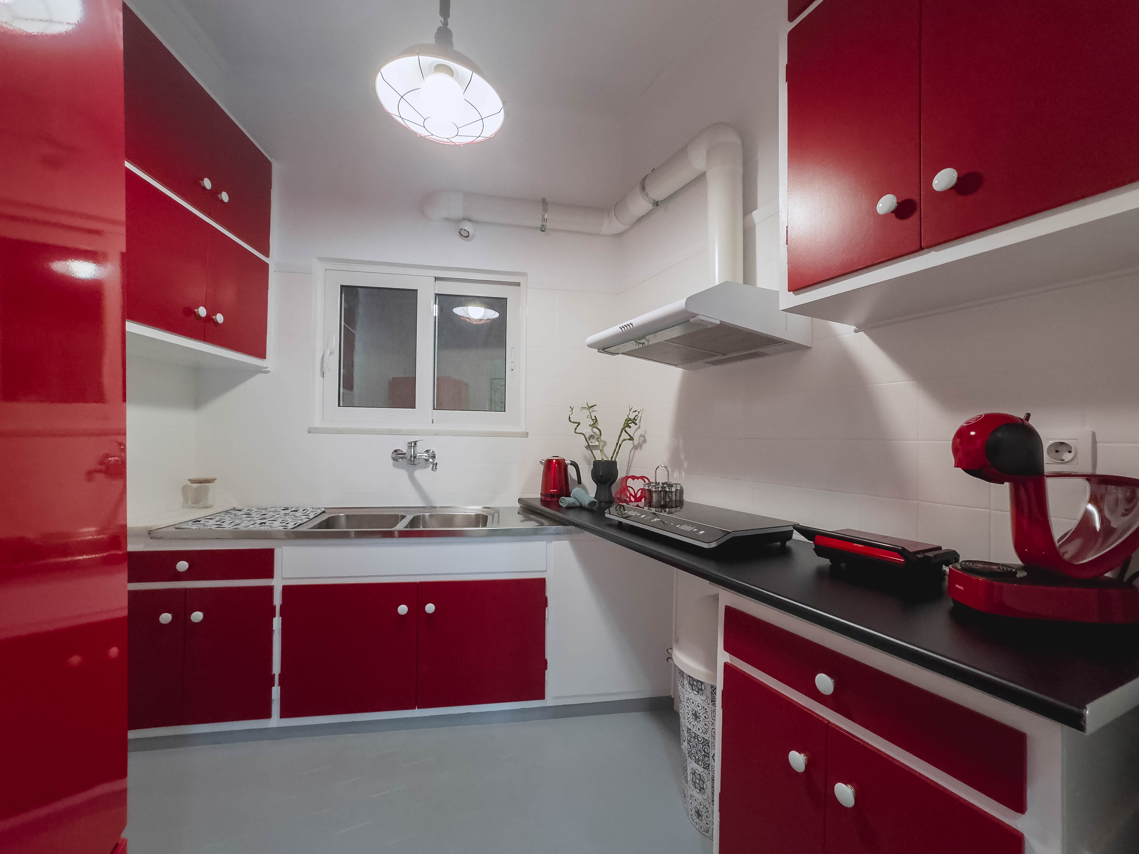 Modern fully equipped kitchen with induction stove and appliances