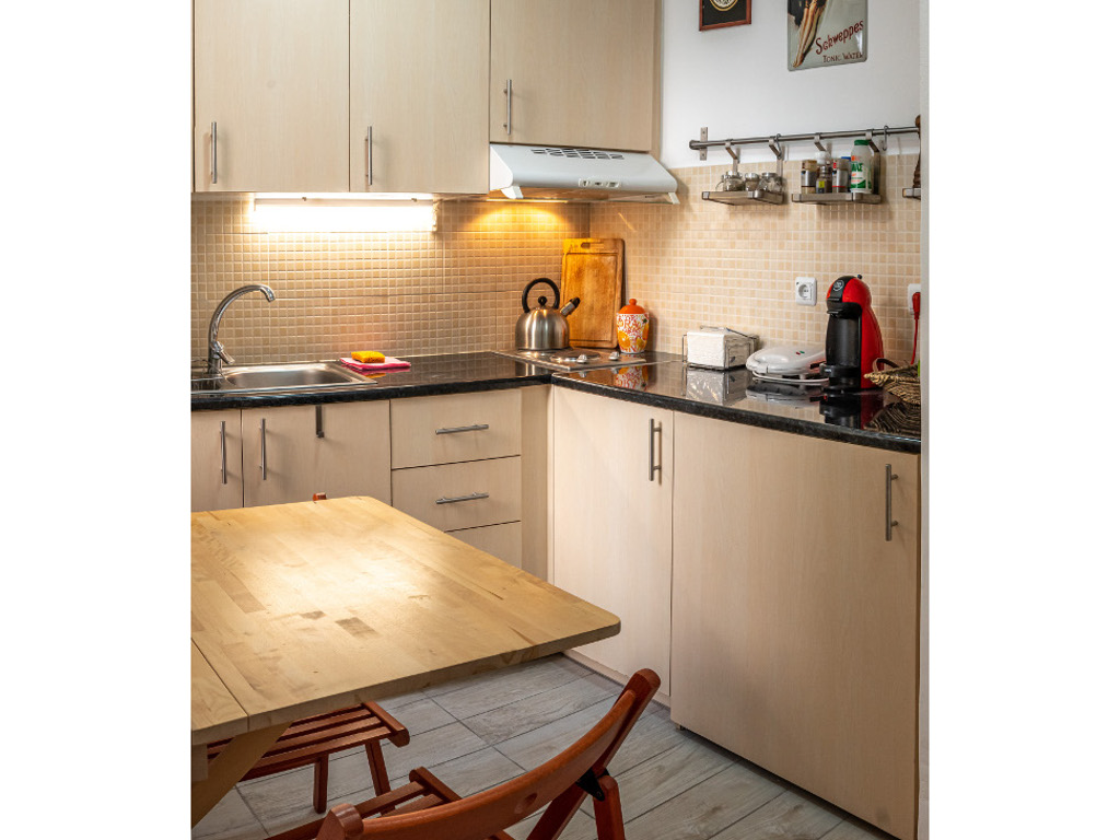 Kitchen with foldable dining table set for two guests